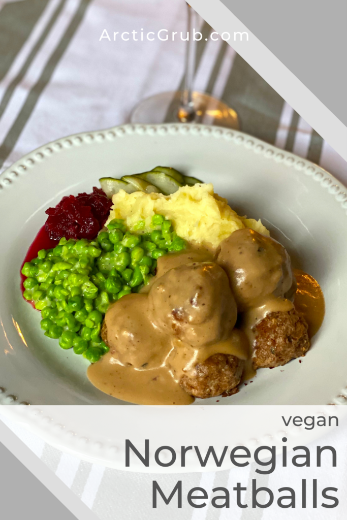 vegan meatless meatballs drizzled with flavorful gravy and served with mashed peas, mashed potatoes and ligonberry sauce